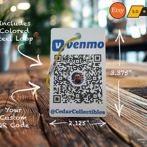 May include: White rectangular tag with a black and white QR code, a small American flag, and the text "venmo" and "@CedarCollectibles". The tag is 3.375 inches tall and 2.125 inches wide. It includes a yellow lanyard with a silver loop.