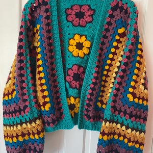 Crochet Pattern  | The Scrap Yarn Cropped Flower Cardigan featuring balloon sleeves and beautiful african flowers
