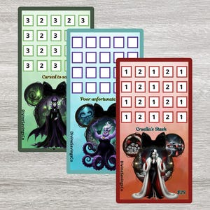 May include: Three rectangular savings challenge cards featuring Disney villains. The green card shows Maleficent, the blue card shows Ursula, and the red card shows Cruella de Vil. Each card has a grid of numbered boxes and character-themed artwork.