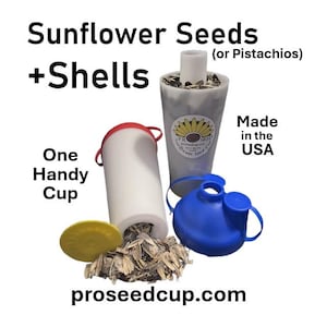 May include: A white cylindrical cup with a red lid, a blue lid with two openings, and a grey cup containing sunflower seeds. Text on the image includes Sunflower Seeds (or Pistachios) + Shells, One Handy Cup, Made in the USA, and proseedcup.com.