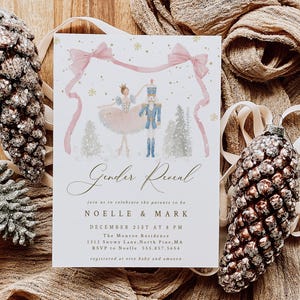 May include: A rectangular gender reveal invitation card featuring a watercolor illustration of a ballerina and a nutcracker under a pink ribbon. The text reads Gender Reveal, Noelle & Mark, December 21st at 8 PM, The Monroe Residence, 1313 Snowy Lane.