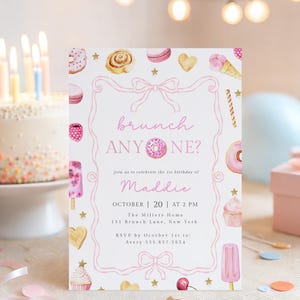 May include: A white rectangular invitation card featuring a pink bow border and watercolour illustrations of sweets including doughnuts, cupcakes, and ice cream. The text reads: brunch ANYONE? join us to celebrate the 1st birthday of Maddie OCTOBER 20 AT 2 PM.