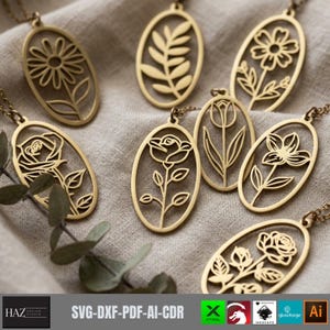May include: A collection of gold-toned oval pendants, each featuring a unique laser-cut floral or botanical design. The pendants are attached to thin metal chains and display various plant motifs including roses, daisies, and leaves.