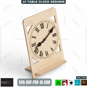 May include: A wooden table clock with a Roman numeral clock face. The clock is light brown and has a rectangular shape with a stand. The text "10 TABLE CLOCK DESIGNS" is at the top. The clock hands are black. The clock is approximately 8 inches tall.