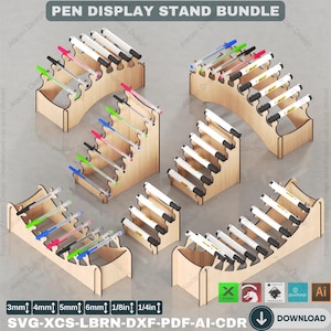 May include: A bundle of five wooden pen display stands in various sizes, ranging from 3mm to 1/4 inch. The stands are made of light brown wood and feature a variety of designs, including a curved stand, a stepped stand, and a straight stand. The stands are shown with pens inserted, showcasing their functionality.
