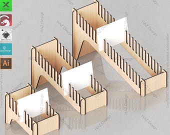 May include: A set of three wooden card display stands. The stands are made of light-coloured wood and feature a slotted design to hold cards. Each stand holds a white card. The text "CARD DISPLAY STAND SET" is at the top.