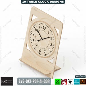May include: A wooden table clock with a circular clock face and black hands. The clock is set in a light-colored wooden frame with a stand. The text "10 TABLE CLOCK DESIGNS" is at the top. The clock measures approximately 8 inches in height.