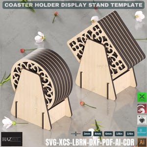 May include: A wooden coaster holder display stand template with intricate cutouts. The stand is designed to hold six coasters, which are stacked on top of each other. The stand is made of light brown wood and has a triangular shape. The template is available in SVG, XCS, LBRN, DXF, PDF, AI, and CDR formats.
