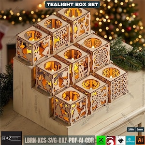 May include: A wooden tealight box set with nine individual candle holders. Each cube features intricate laser-cut designs, including stars, trees, and snowflakes. The text "TEALIGHT BOX SET" is at the top. The set is displayed on a white stepped platform.