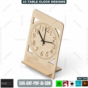 May include: A wooden table clock with a light brown finish. The clock face features black hands and a minimalist design with the numbers 1 through 12. The clock is supported by a stand. The text "10 TABLE CLOCK DESIGNS" is at the top.