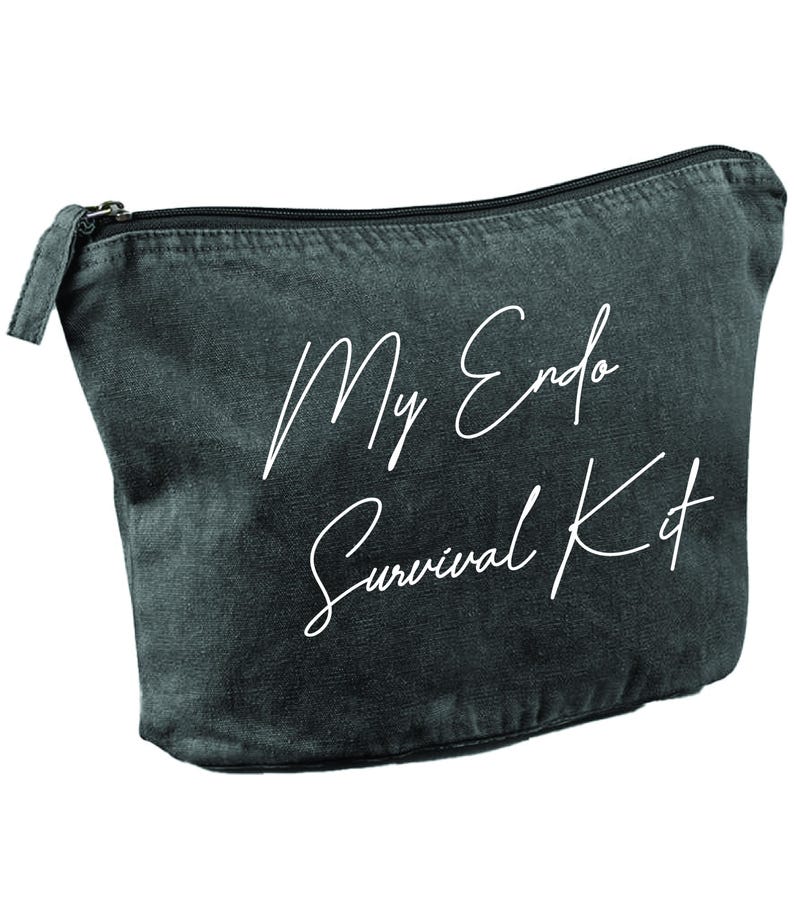 May include: A dark gray zippered pouch with the text "My Endo Survival Kit" in white script. The pouch is made of a soft, textured material and has a black zipper.