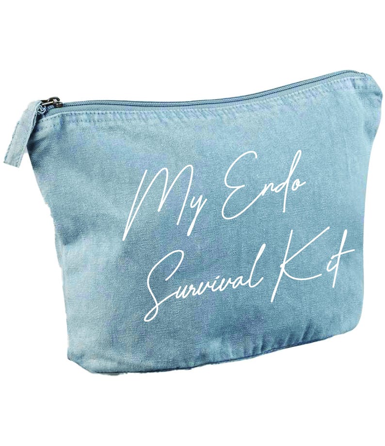 May include: A light blue denim-style zippered pouch with the text "My Endo Survival Kit" in white script. The pouch has a rectangular shape with a curved top and a silver zipper.