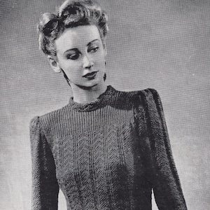 May include: A vintage knitting pattern for a roll-collar jumper, featuring a black and white photo of a woman wearing the finished garment. The pattern is from Weldons Leaflet No. 480 and requires 8 ounces of 3-ply yarn.