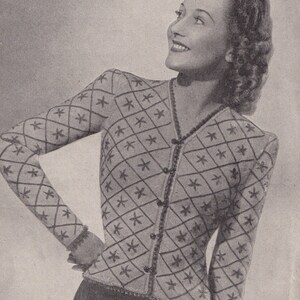 May include: A black and white photo of a woman wearing a cardigan with a diamond pattern. The cardigan is knitted with a white yarn and has a V-neck. The woman is wearing a skirt and has her hair styled in a curly updo. The text on the image reads "AFLET 3d No. 662 8 ozs. of 3-ply, White; 1 1/2 ozs. Blue; 1/2 oz. Red."