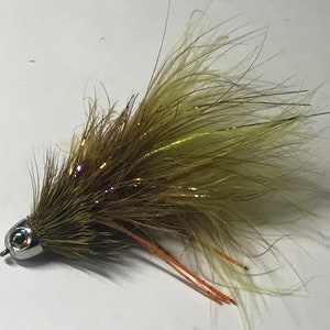 May include: A brown and green fly fishing lure with a silver head and orange accents.