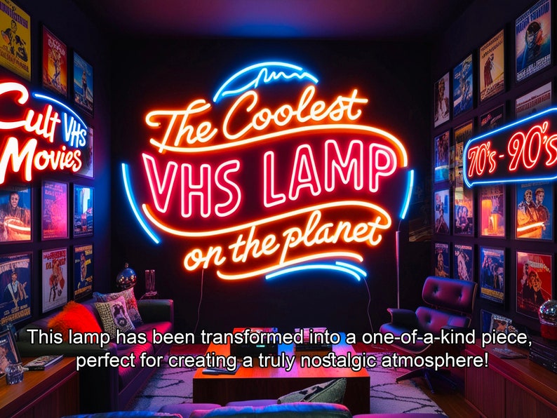 May include: A neon sign that reads "The Coolest VHS LAMP on the planet" in a retro style. The sign is mounted on a black wall with other neon signs and vintage movie posters.