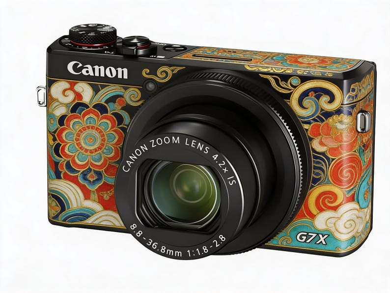 May include: Black Canon G7X digital camera with a decorative floral pattern in red, blue, and gold. The camera lens is black, and the text "Canon Zoom Lens 4.2x IS" is visible. The camera also has the text "G7X".