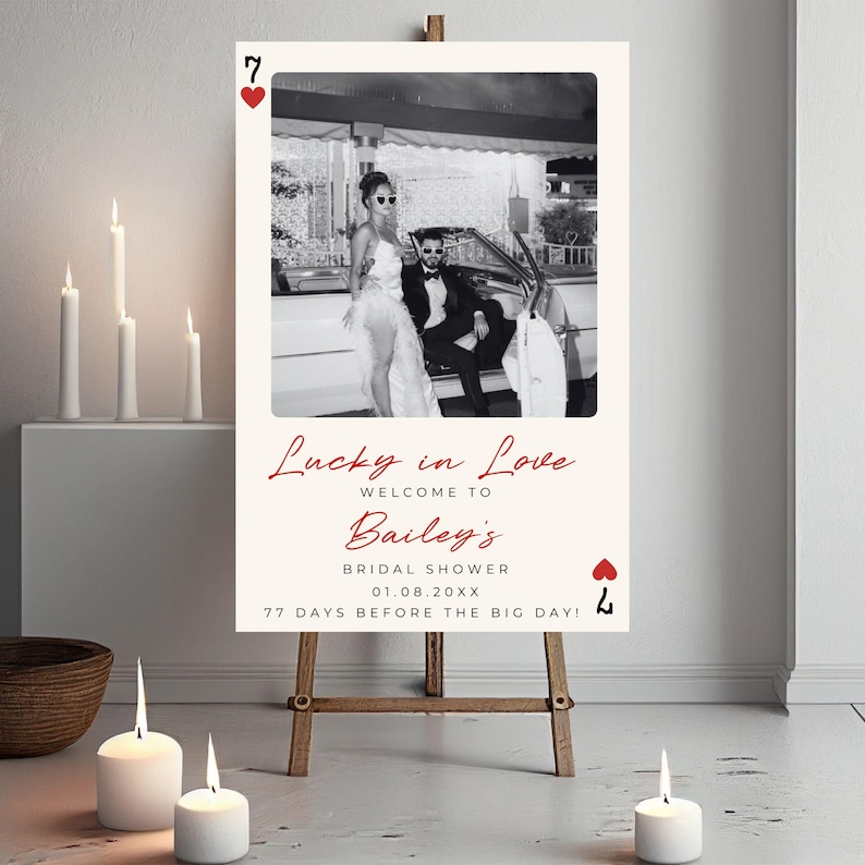 Puede incluir: Una foto en blanco y negro de una pareja en un coche con un coraz&oacute;n rojo y el texto "Lucky in Love" en cursiva roja. El texto "Welcome to Bailey's Bridal Shower 01.08.20XX 77 Days Before The Big Day!" tambi&eacute;n est&aacute; en rojo.