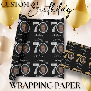 May include: Custom birthday wrapping paper featuring a repeating pattern of a person's photo, the number 70, and the words "happy birthday." The design is on a black background with gold and silver accents. The words "Custom Birthday" and "WRAPPING PAPER" are also visible.