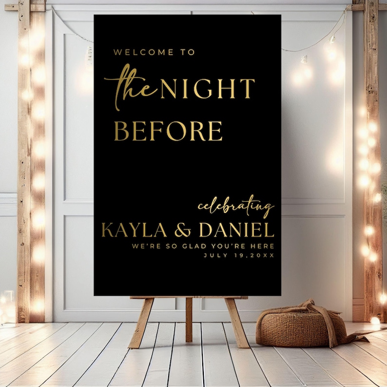 May include: Black welcome sign with gold lettering that reads "Welcome to the Night Before celebrating Kayla & Daniel We're so glad you're here July 19, 20XX"