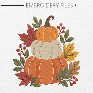 May include: An embroidery design featuring a stack of three pumpkins in orange and cream colors, surrounded by autumn leaves in red, yellow, and brown, along with green foliage and red berries. The text EMBROIDERY FILES is at the top.