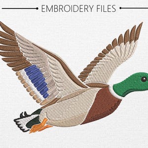 May include: An embroidery design of a mallard duck in flight with a green head, yellow beak, brown chest, and wings featuring white, brown, and blue feathers. The text EMBROIDERY FILES is centered above the duck on a white textured background.