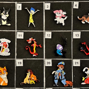 May include: A collection of cartoon character charms, including a rabbit with a flower, a girl with arms raised, a white cat with a pink bow, and a brown dog. Other charms feature a dragon, a lion, and a fox in a police uniform.
