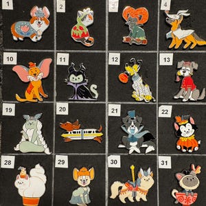 May include: A collection of sixteen enamel pins arranged in a grid, each featuring a stylized animal character in a costume. The pins include various dogs and cats dressed as figures, such as a corgi, a mummy dog, and a cat in a teacup, numbered 1-31.