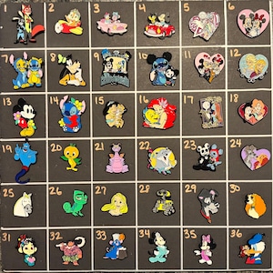 May include: A collection of 36 colorful enamel pins featuring various Disney characters. The pins are arranged in a grid on a dark gray surface. Characters include Mickey Mouse, Stitch, Ariel, and others. Each pin is a unique design.