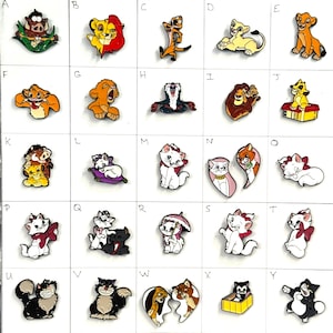 May include: A collection of colorful enamel pins featuring characters from Disney's The Lion King and The Aristocats. The pins include Simba, Nala, Timon, Pumbaa, and Marie. The pins are in various poses and designs.