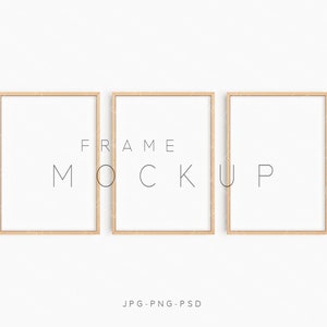May include: Three wooden picture frames with white mats and a white background. The frames are arranged in a row, with the middle frame slightly higher than the other two. The text "FRAME MOCKUP" is printed in black below the frames.