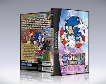 May include: A blue Sega Dreamcast game case with a blue and white background. The front of the case features a cartoon image of Sonic the Hedgehog. The title of the game, "Sonic Adventure", is printed in white letters on the front of the case.