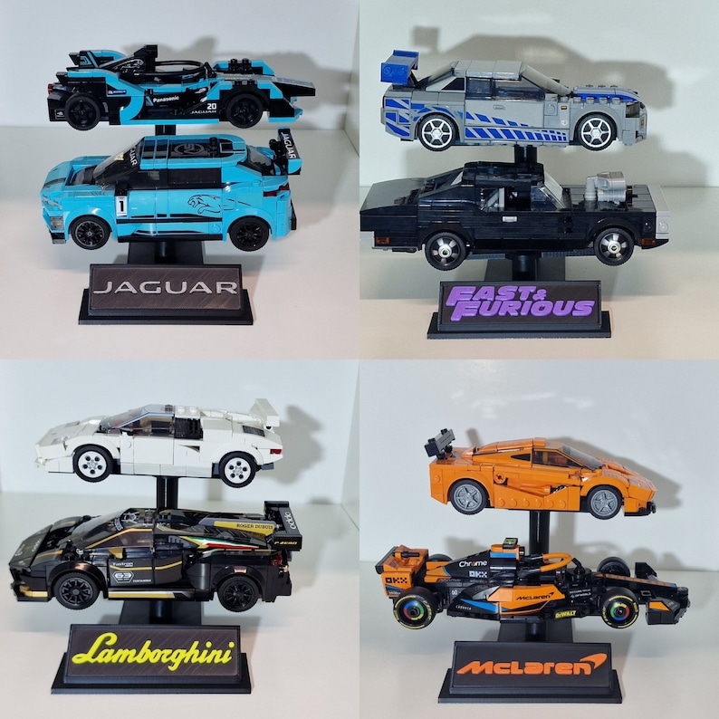May include: A collection of toy cars, including a blue and black Jaguar, a gray and blue car, a white Lamborghini, and an orange McLaren. Each car is displayed on a black stand with the car's brand name.