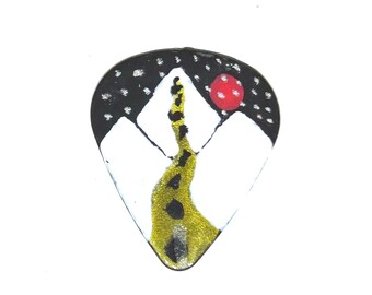 Road through snowy mountains guitar pick