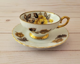 Unmarked china yellow rose tea cup and saucer