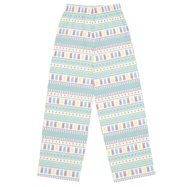 May include: Light blue pajama trousers featuring a repeating pattern of colourful Easter bunny figures. The design includes rows of bunnies in yellow, purple, and pink, interspersed with geometric shapes and stripes. The trousers are made of a soft material.