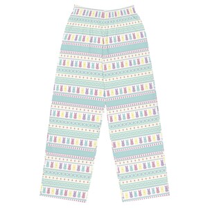 May include: Light blue pajama trousers with a repeating pattern of colourful Easter bunny figures. The trousers feature horizontal stripes with the bunnies in yellow, purple, and pink. The background is a light blue colour.