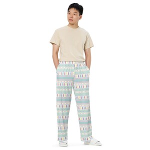 May include: Light blue pajama trousers with a repeating pattern of Easter bunnies in pastel colours. The trousers have a white waistband and a relaxed fit. The pajama trousers are made of a soft, comfortable material.