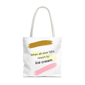 May include: White canvas tote bag featuring the text "When all else fails, resort to ice cream." The text is surrounded by three colourful brushstrokes: brown, yellow and pink.
