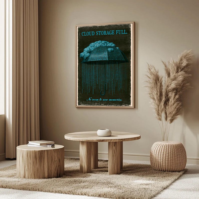 Vertical poster on a sideboard next to wicker-front storage and a sofa. Shows the full binary umbrella and falling code; distressed beige border and pale script subtext can be seen at the bottom.