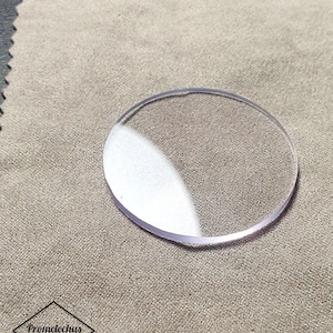 May include: A clear, round, watch crystal replacement.