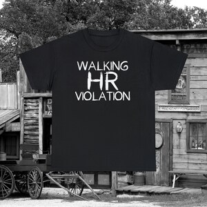 May include: Black t-shirt with white text that reads "Walking HR Violation".