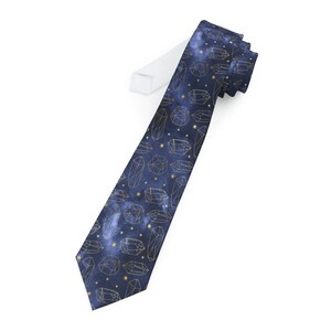 May include: A dark blue tie with a pattern of gold geometric shapes and stars.