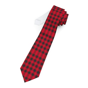 May include: A red and black plaid tie. The tie is made of a smooth fabric and has a pointed tip.