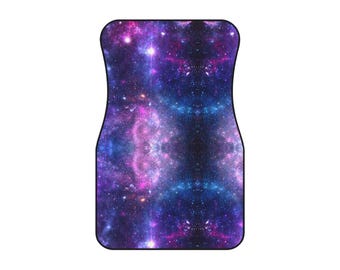 May include: Car floor mat with a vibrant galaxy design. The mat features a cosmic pattern with shades of purple, blue, and pink, creating a celestial aesthetic. The mat is designed to fit a car's floor and protect it from dirt and debris.