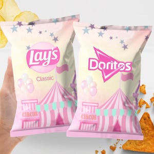 May include: Two pink bags of Lay's Classic and Doritos chips with a circus theme. The bags feature a pink and white circus tent design, balloons, and stars. The Lay's bag has the word "Classic" on it.