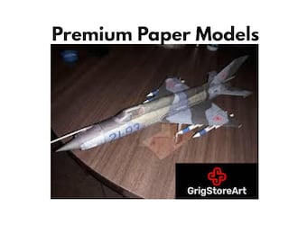 May include: A paper model of a fighter jet featuring a camouflage pattern in shades of gray and green, with the number 2193 printed on the side. The text Premium Paper Models and the logo for GrigStoreArt are visible in the image.
