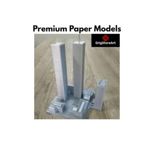May include: A gray paper model of two tall rectangular skyscrapers and smaller surrounding buildings on a square base. The text Premium Paper Models and the logo GrigStoreArt are visible at the top of the image against a light background.