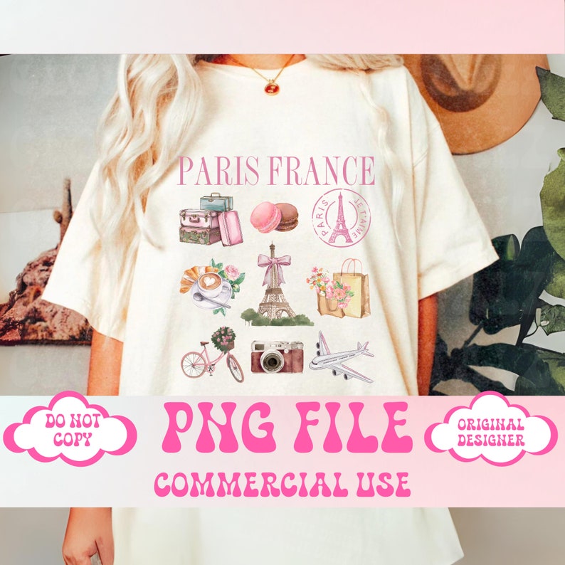 May include: A white t-shirt with a pink graphic design featuring a variety of Parisian-themed illustrations, including the Eiffel Tower, macarons, a bicycle, a camera, and a suitcase. The text "Paris France" is printed in pink at the top of the design. The text "PNG File Commercial Use" is printed in pink at the bottom of the design.