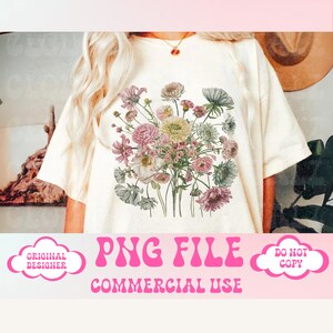 May include: Cream-colored t-shirt featuring a floral bouquet design in shades of pink, green, and white. The text "PNG FILE" and "COMMERCIAL USE" are displayed in pink, retro-style font.